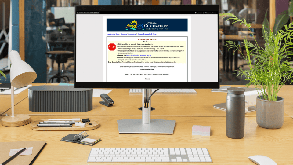 A computer in an office setting with the SunBiz Portal on the screen