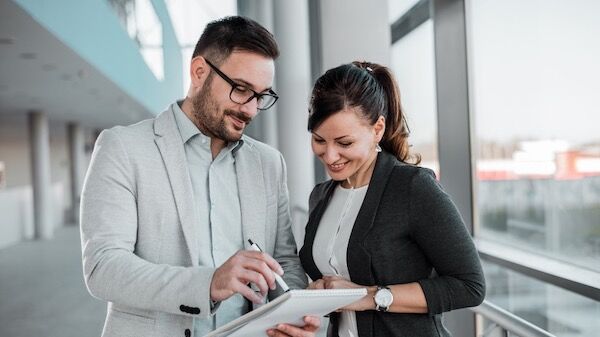 Two businesspeople looking at a tablet