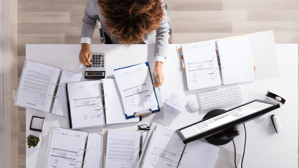An overhead view of a person working at their desk