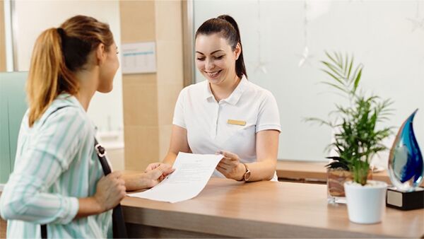 Two people talking and looking at a piece of paper