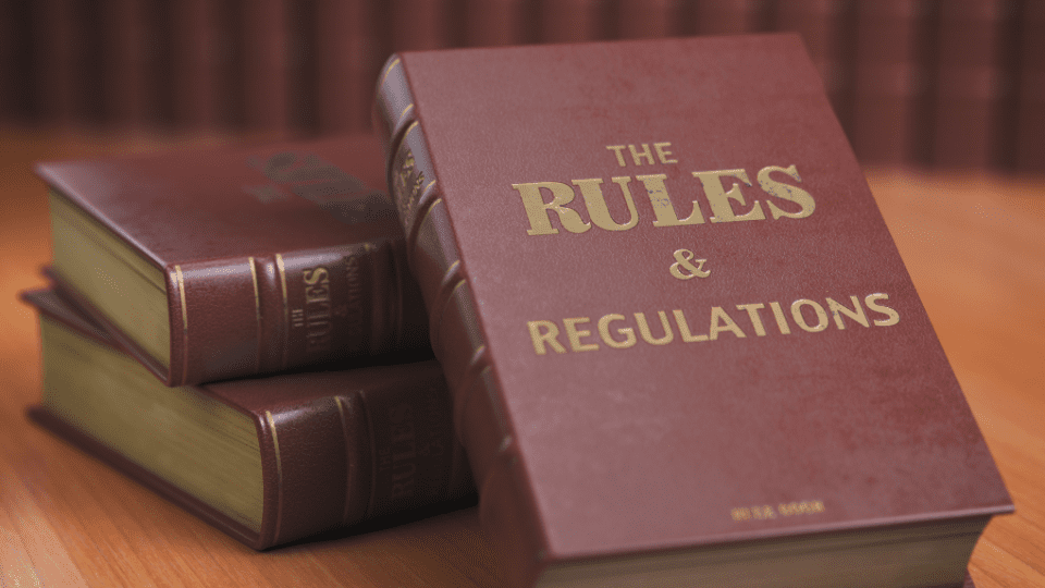 A stack of books with the words the rules and regulations on them